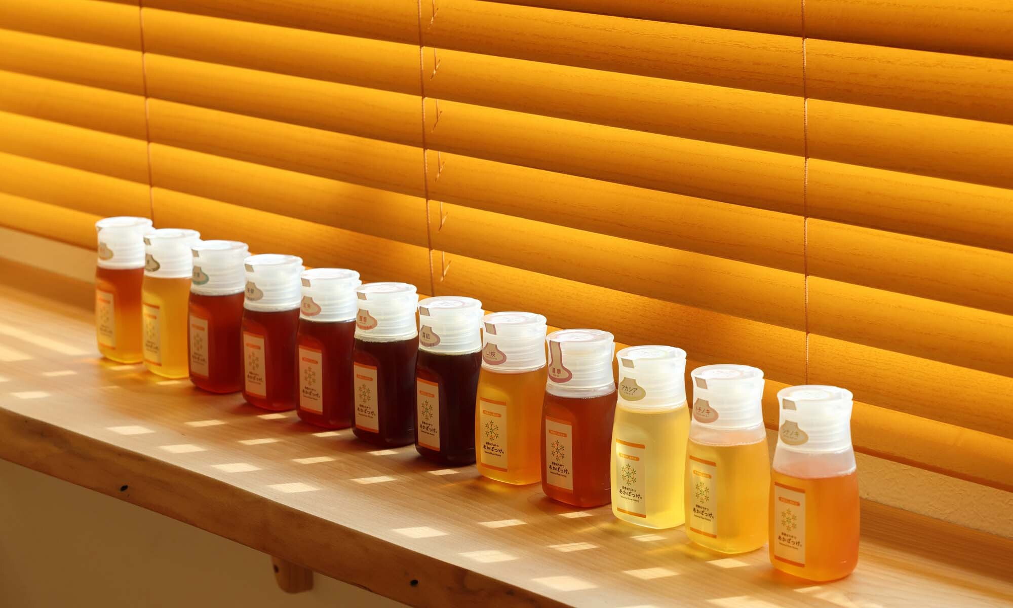 窓辺に並ぶ試食用のはちみつ